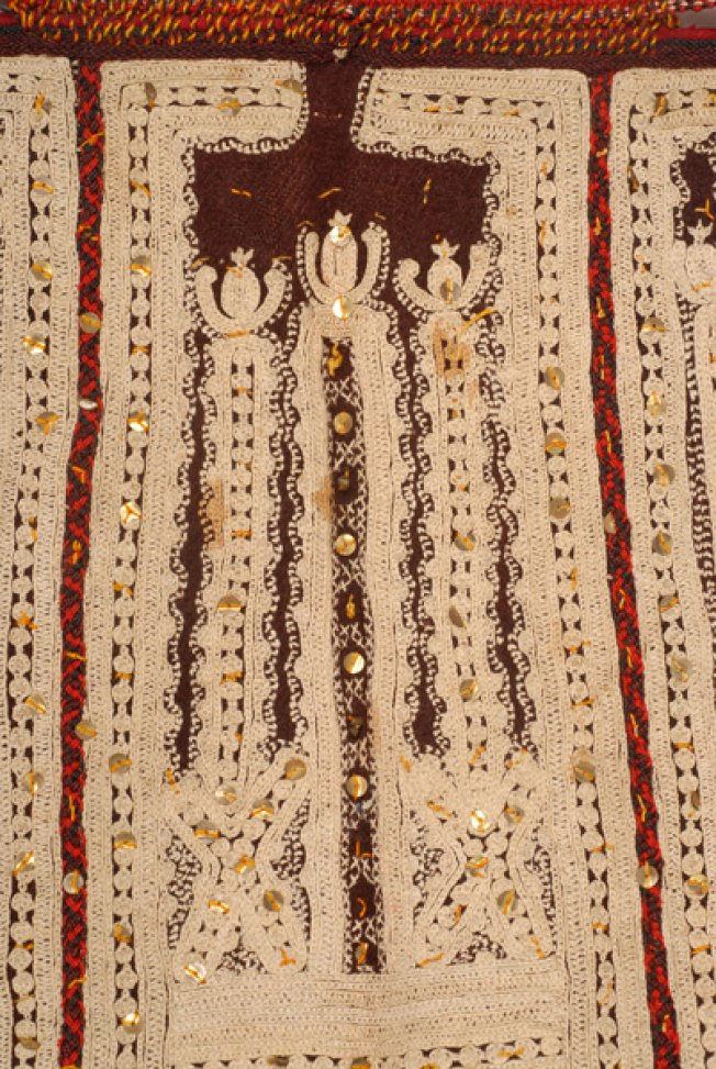 Detail of the embroidered decoration with linen rammata and applique spangles. At the panel joint, embroidery with colourful woollen thread