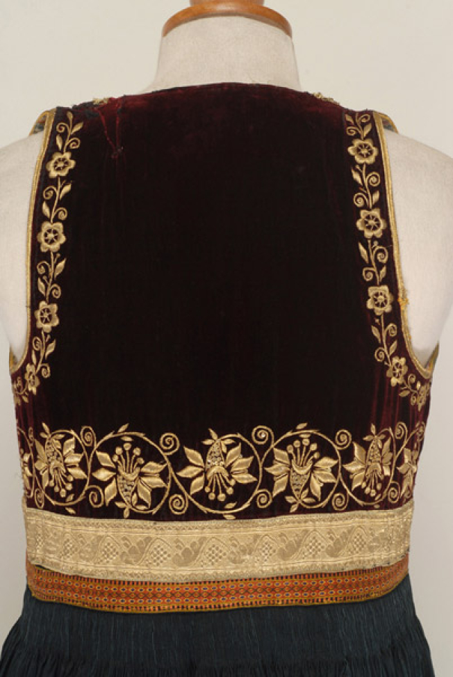 The back, detail of the gold embroidered decoration at the frame