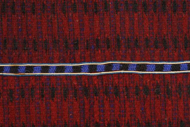 Horizontal joint, detail of the decoration with narrow embroidered band 
