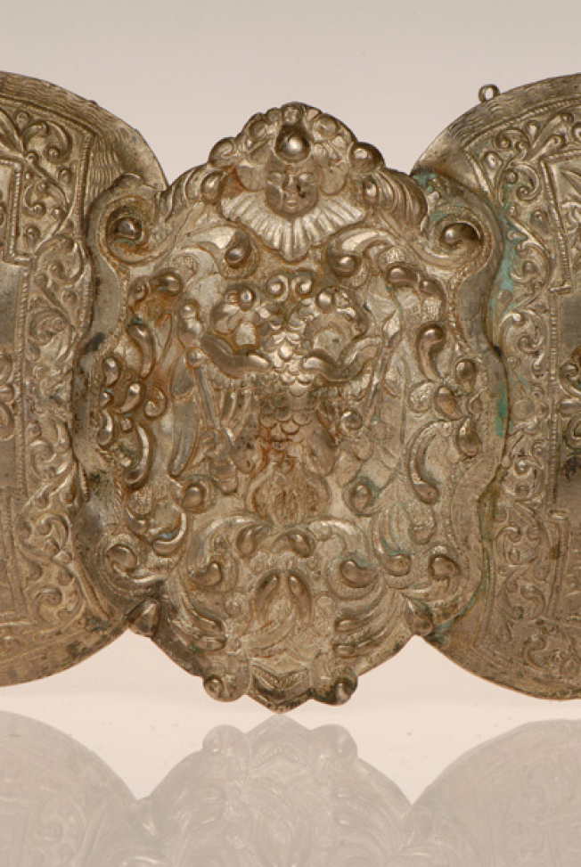Detail of the decoration of the central embossed element. Vegetal decoration on all sides, a double-headed eagle in the centre and a hideous human head at the top
