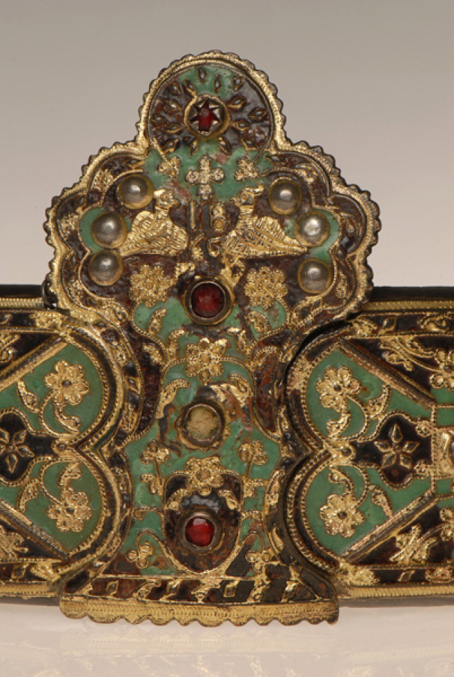 Detail of the decoration with colourful enamel, colourful stones, flowers and two birds facing each other at the top of the buckle