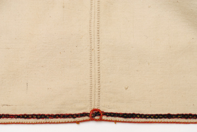 Side seam, embroidered band and a circle from cordon