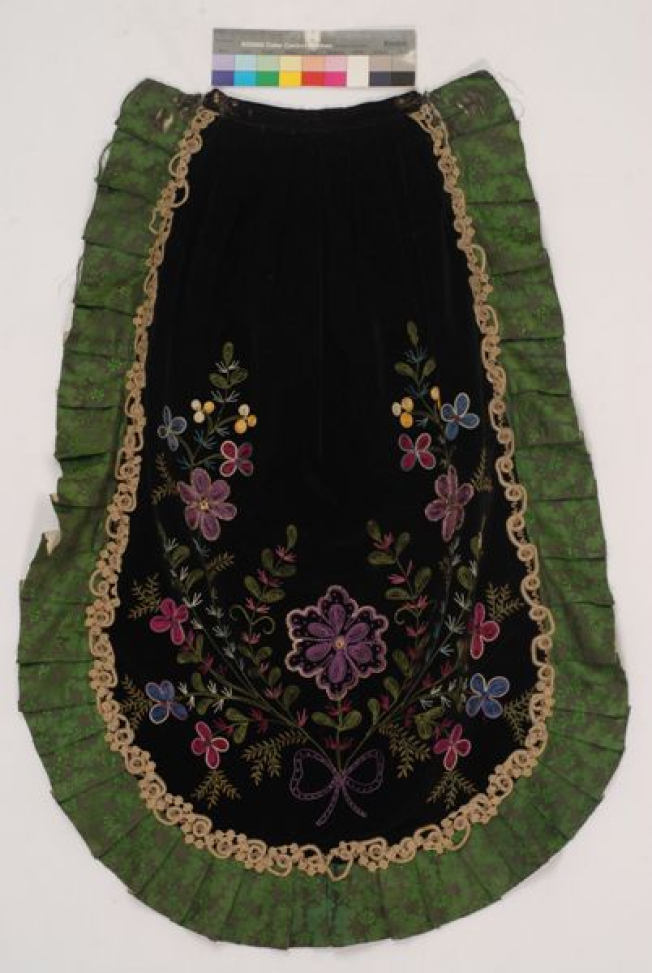 Black velvet apron embroidered with multicoloured silk threads. Trimmed around with flounce made of green satin