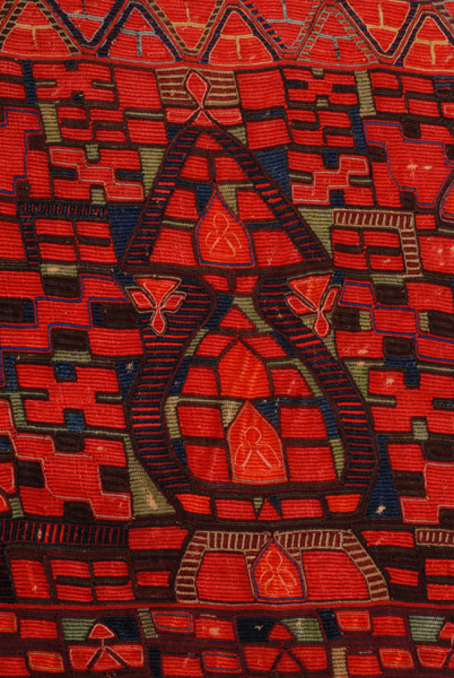 Detail of the embroidery: three vertical female figures and "double mastrapas (pitcher)".