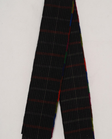 Foukas, woollen woven sash with embellished stripes. At the one edge, the decoration with the small ploumidia (finery) is crafted with the embroidery needle
