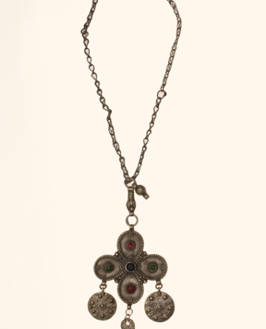 Silver cross decorated with variegated glass stones and suspended grainy elements
