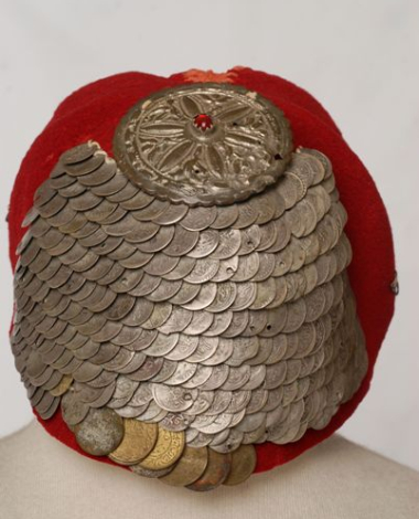 Paradomeno tarbush. Applique decoration with silver coins and a metal tassel with a red stone in the centre