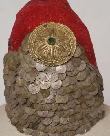 Paradomeno tarbush. Applique decoration with silver coins and a metal tassle with a green stone in the centre