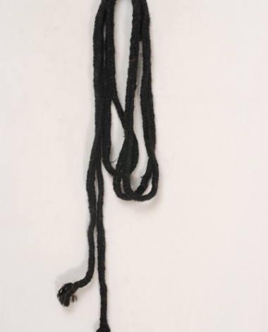 Πλεχτό μαύρο μάλλινο κορδόνι, εξάρτημα της γυναικείας φορεσιάς των Αλώνων
