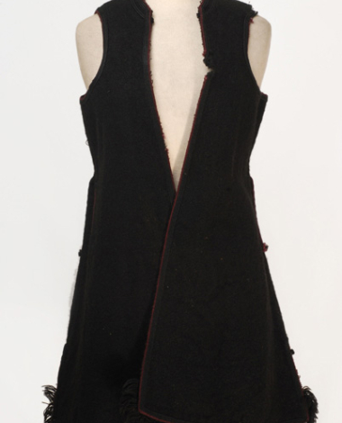 Sleeveless outer overcoat made of black horse-cloth, ornamented with plain coloured cordons and woollen fringes