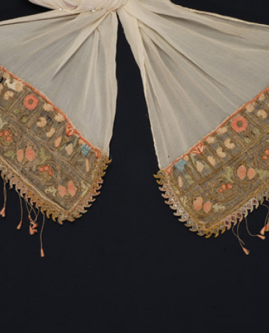 Corner of a bolia from Psara with rich gold embroidery and colourful silk fabrics