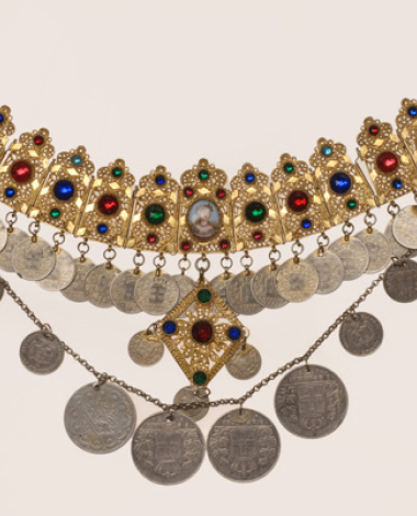 Gilt filigree yordani decorated with colourful glass stones, a miniature and coins