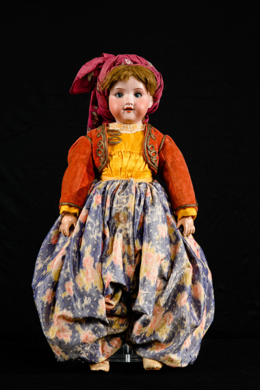 Doll with a bisque porcelain head and composition jointed limbs, dressed in the local women’s costume of Lesvos. At the back of the head is the factory stamp “Armand Marseille Germany 390 A.O.M”, partially hidden under the sheep wool hair. Part of the doll collection donated by Queen Olga to the LtE in 1914. CMLE, Accession No. 14508. Photo: Studio Kominis.