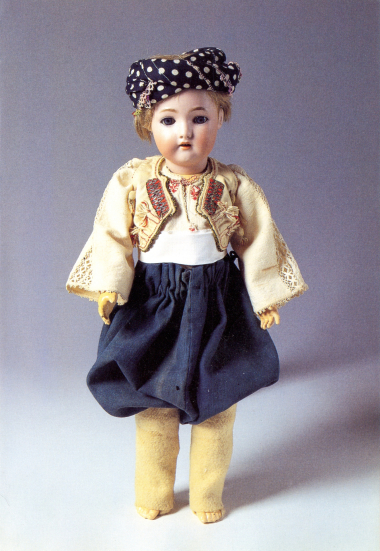 Doll with a bisque porcelain head and composition jointed limbs, dressed in the local male shepherd’s costume of Skyros. At the back of the head is the factory stamp "S & C, Simon & Halbig, 6 ½", partially hidden under the sheep wool hair. Part of the doll collection donated by Queen Olga to the LtE in 1914. CMLE, Accession No. 14488.