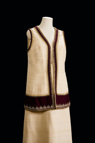 Ensemble consisting of a skirt and sleeveless waistcoat, inspired by the Court outfits established by Queen Olga, which had elements of the sleeveless woolen coats worn in Attica. Created by the workshop “Amalia K. Frontzos” in Ioannina. CMLE, Accession No. 14555/1-2. Photo: Studio Kominis.