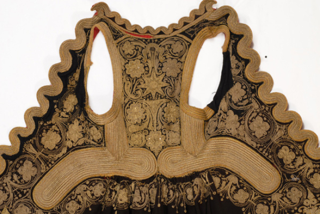 Detail of terzidikos (gold tailored) embroidery at the bottom of the overcoat, in the centre: one of the three big stylized vegetal motifs