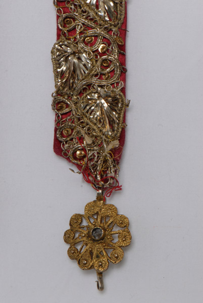 Rosette and detail of the gold embroidered