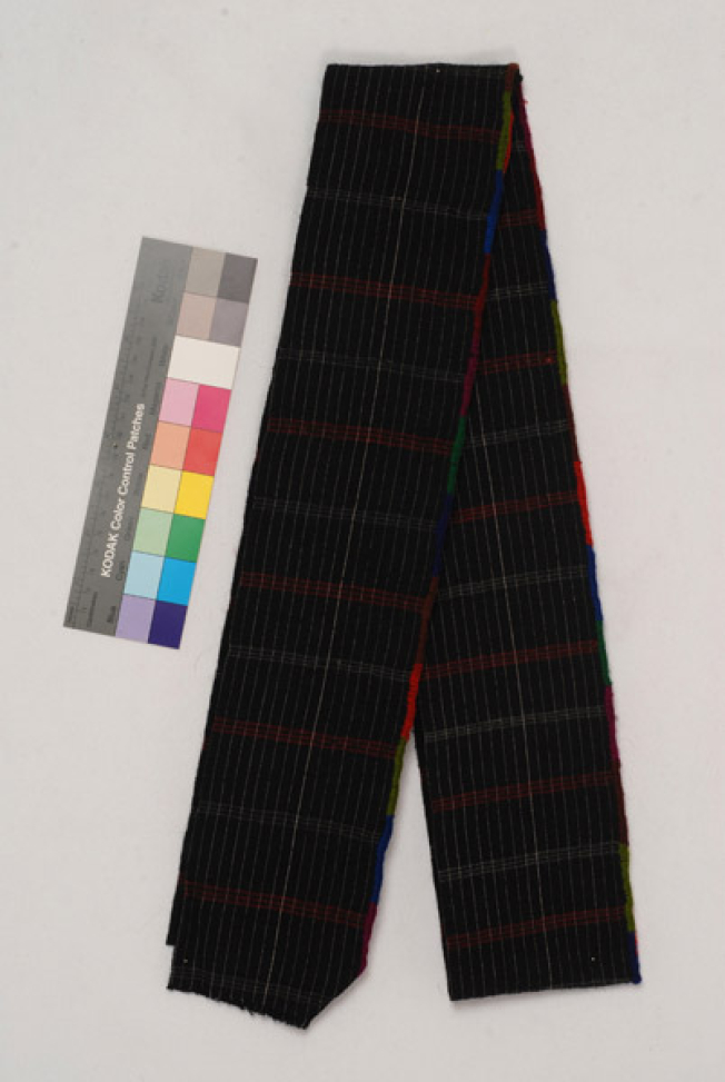 Foukas, woollen woven sash with embellished stripes. At the one edge, the decoration with the small ploumidia (finery) is crafted with the embroidery needle