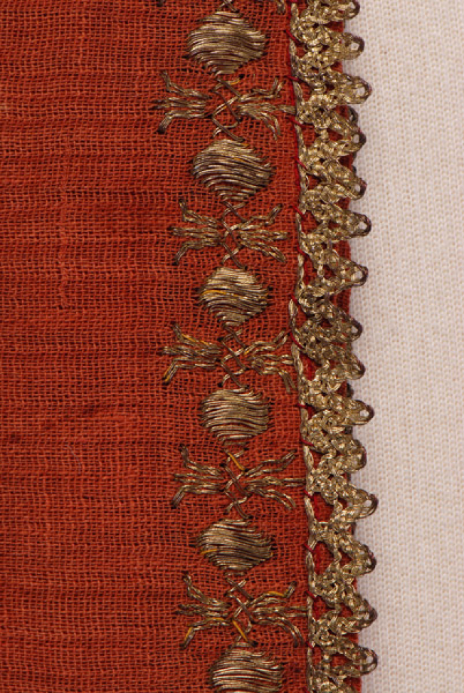 Sleeve, detail of the decorative motif and the lace
