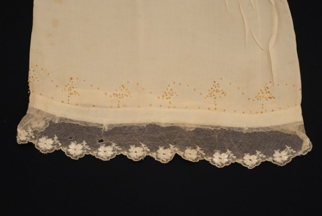 Sleeve, detail of the applique decoration with beads and lace sold by the metre 