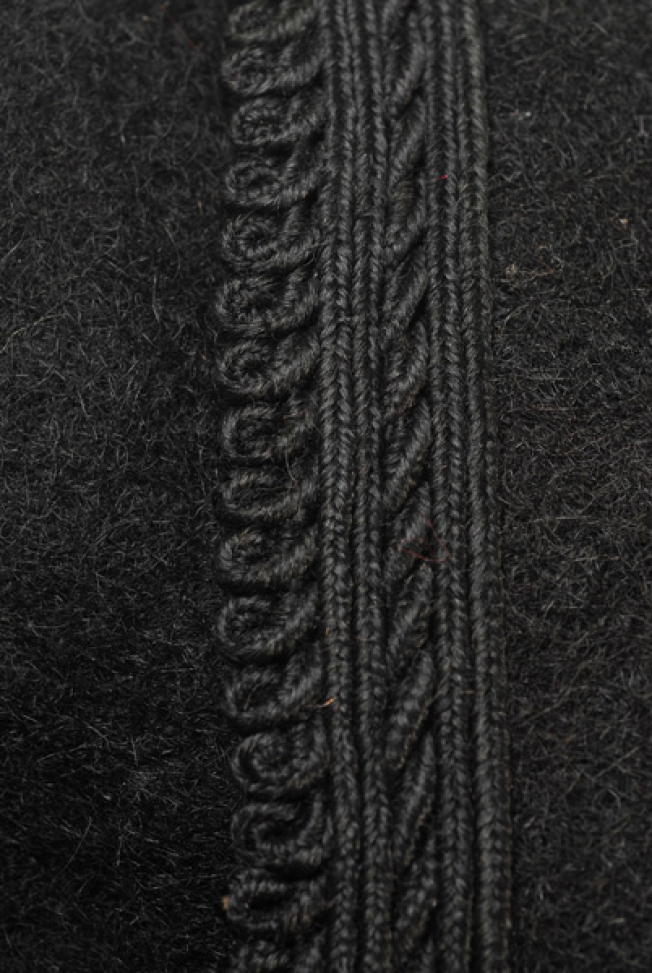 Sleeve, detail of the applique decoration with plain coloured cordons and loops