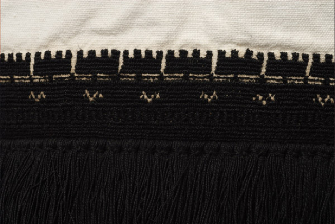 Border, detail of the decoration with thick black embroidery and with a row of cypresses (stylized vegetal decoration)