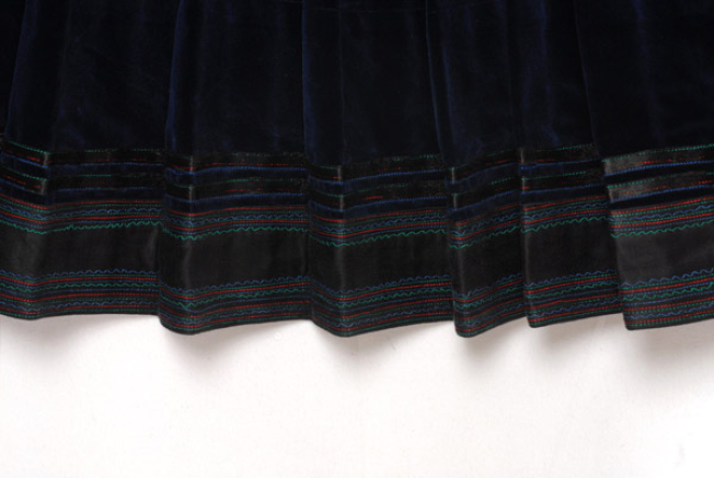 Border, detail of the decoration with ribbons and piece of black satin fabric, trimmed with multicoloured stitches