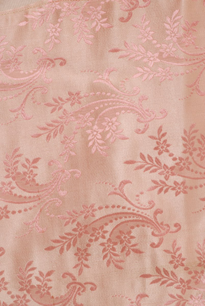 Detail of the embellished decoration of the rich brocaded fabric at the bottom part of the skirt