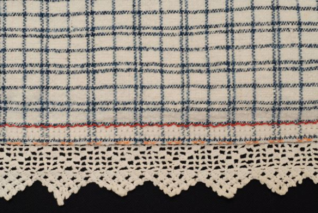 Detail of the decoration at the border, lace crafted with embroidery needle and discreet embroidery