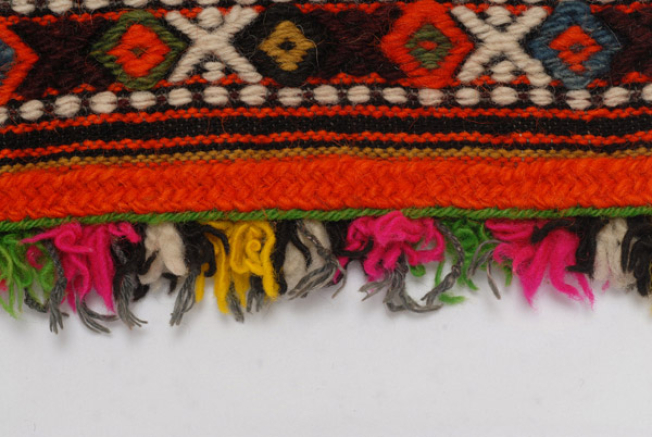 Detail of the decoration, applique wool gaitani, wool cord and small fringes made of fullen wool at the hem 