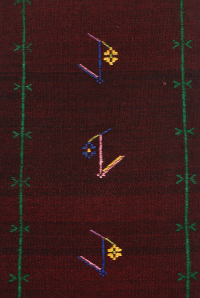 Detail of the decoration, embroidered vertical stripes with stylized vegetal motifs in between
