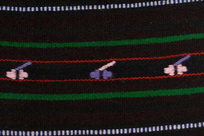 Detail of the decoration, embroidered motifs at the embellished stripes