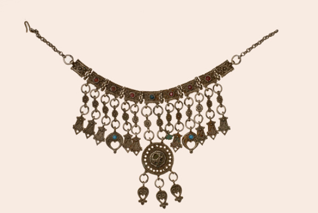 Kremassi, silver ornament (lucky charm) made from oblong cast plates decorated with colourful stones. It has various suspended elements and a central round plate (Northern Sporades?)