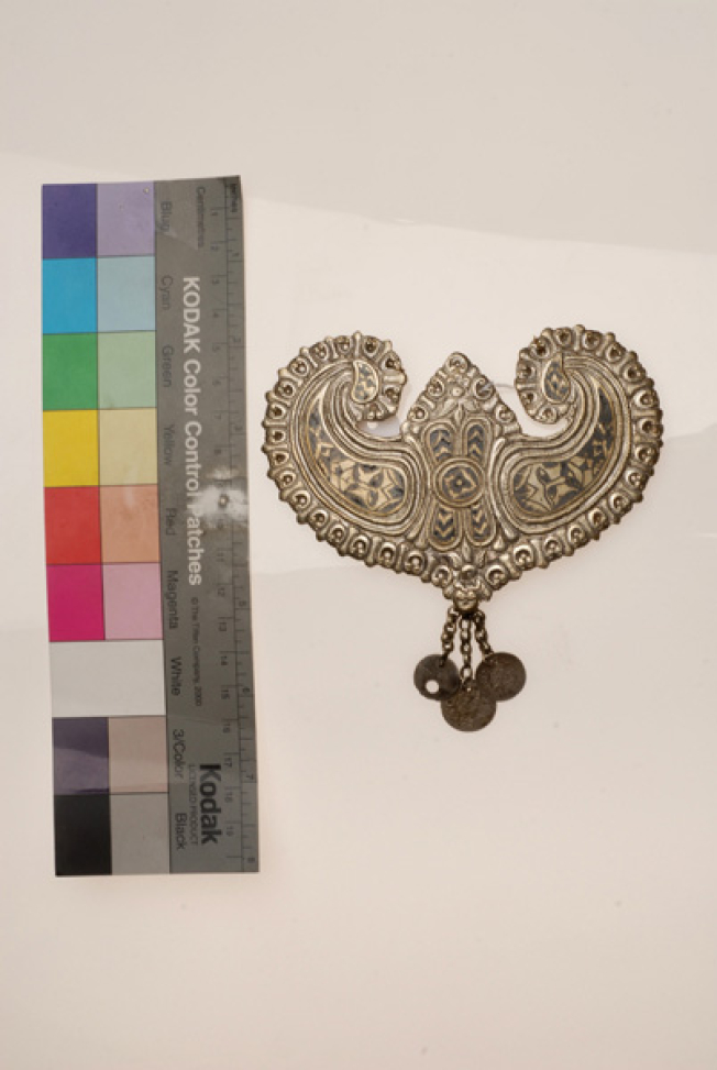 Koumptsi, heart-shaped cast plate with engraved anthropomorphic compositions filled with black "savati" (kind of enamel)