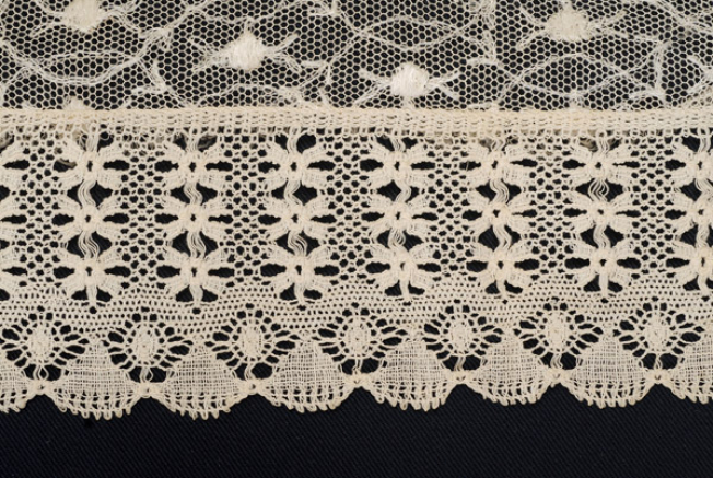 Detail of the decoration, lace with small blossoms