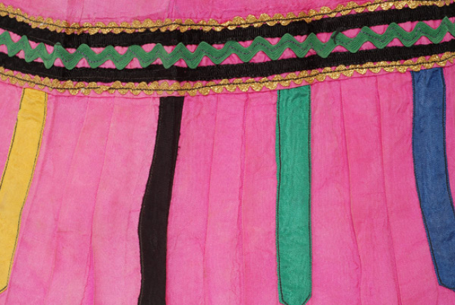 Detail of applique decoration, horizontal braids and polychrome vertical ribbons 