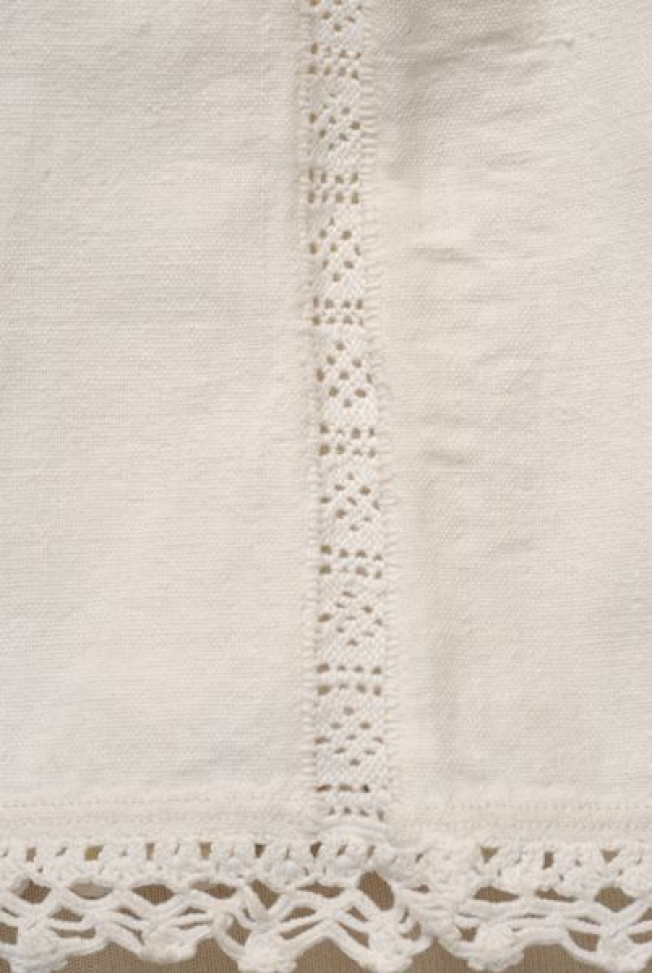 Sleeve seam with white open-work embroidery