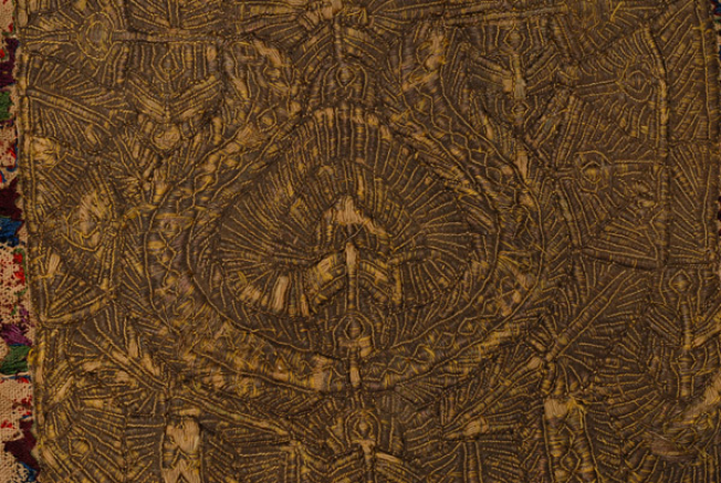 Narrow gold embroidery: shot from up close