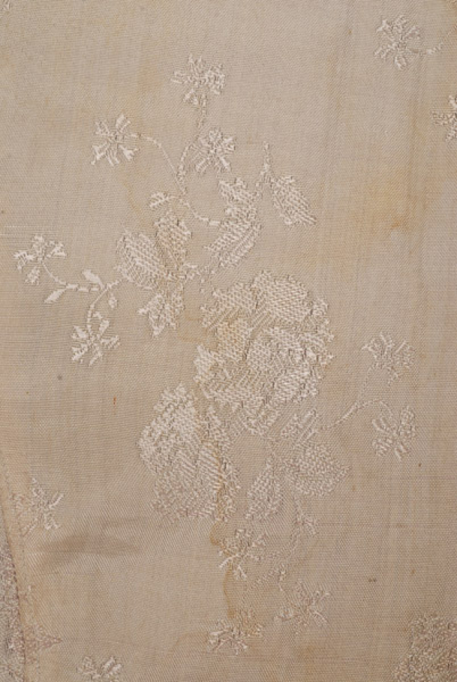 Detail of the embellished decoration at the silk brocaded fabric