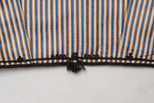 Detail of the decoration at the back, low down at the waist
