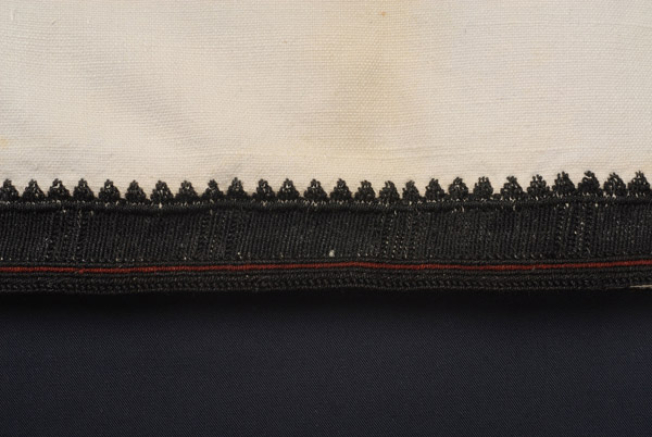 Border, detail of the decoration with black vitses and koukoulia gazisia, stromena with stavrovoulia and full of vertical stitches