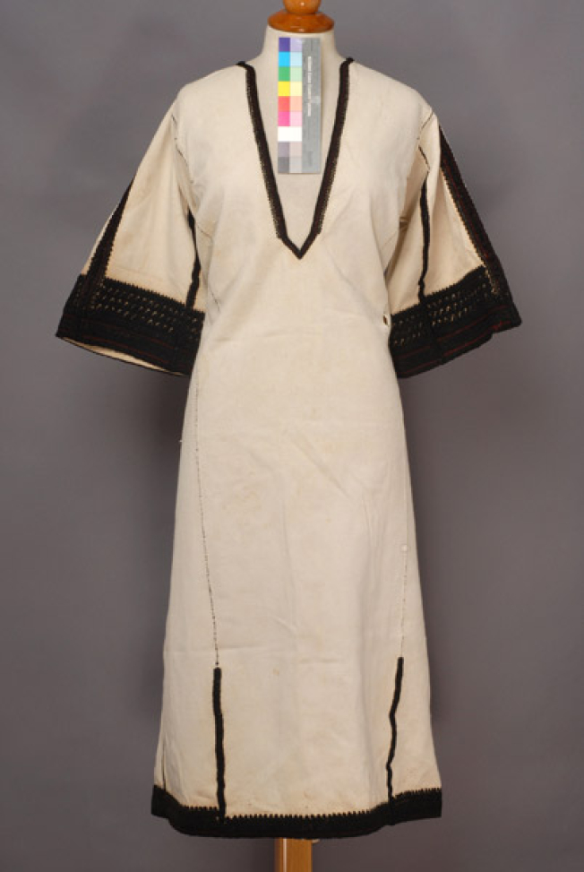 White cotton chemise, embroidered with with black woollen threads 