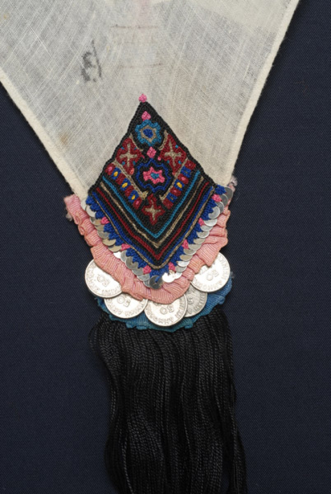 Detail of the decoration, embroidery and applique elements at the one corner of the kerchief