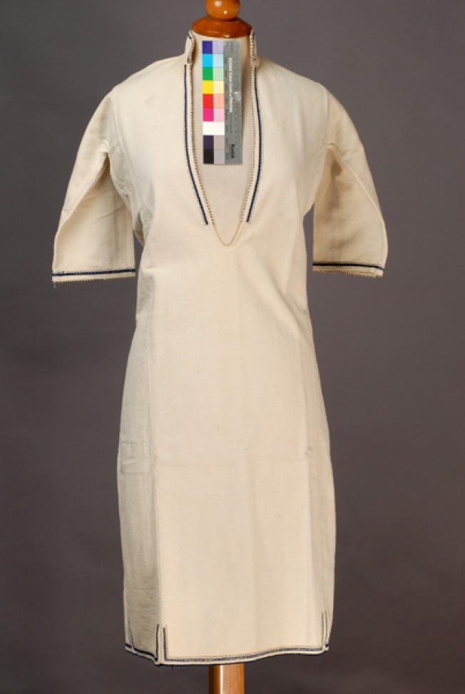 White cotton woven chemise, ornamented with blue and black embroideries