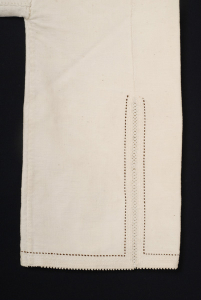 Sleeve, detail of the lacy band of the seam and the embroidered decoration