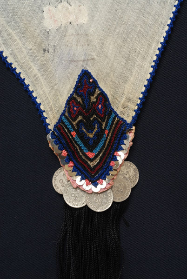Detail of the decoration, embroidery and applique elements at one of the corners of the kerchief