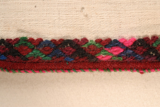 Detail of the embroidered decoration at the front panel of the border: namet and pat