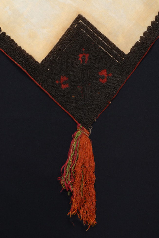 Detail of the embroidered decoration at the corner: big branch with the diagonal red branch and fringes