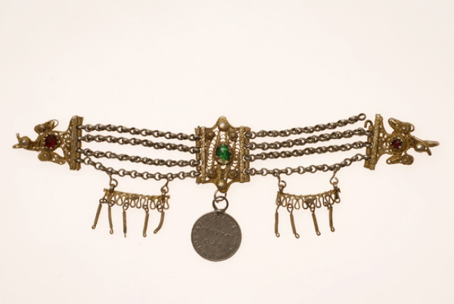 Vastaki, gold plated wiry torso ornament, decorated with coloured glass beads