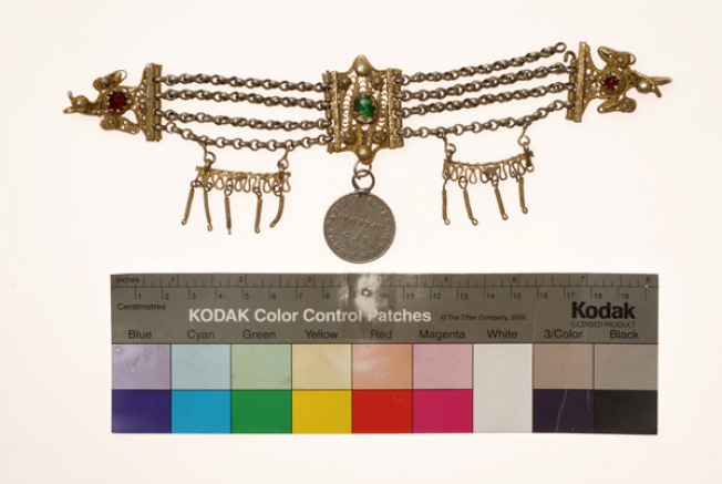 Vastaki, gold plated wiry torso ornament, decorated with coloured glass beads
